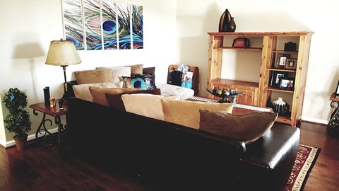 a living room with a couch and a lamp